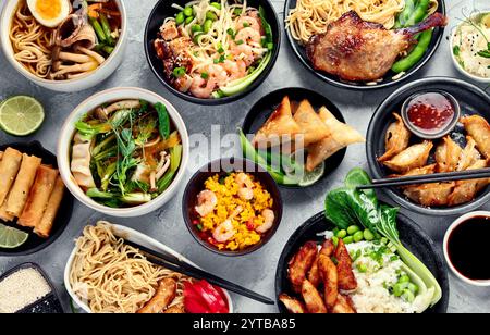 Assorted asian dishes and snacks on dark gray background. Stock Photo
