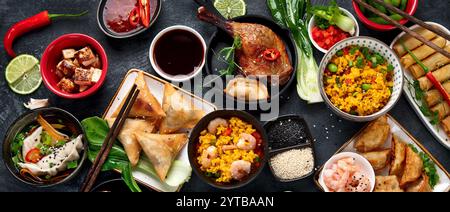 Assorted Chinese dishes and snacks on dark gray background. Traditional food concept. Top view, flat lay Stock Photo