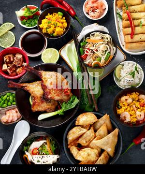 Assorted Chinese dishes and snacks on dark gray background. Traditional food concept. Top view, flat lay Stock Photo