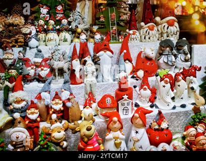 Large collection of red gnomes and other Christmas decorations. The gnomes are arranged in a variety of sizes and positions, creating a festive and ch Stock Photo