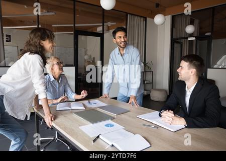 Happy diverse colleagues participate in group meeting event Stock Photo