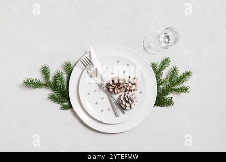 Festive table setting for Christmas dinner with silver cutlery on a white background. View from above. Stock Photo