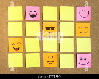 self adhesive office notes with different face expression on cork board as abstract concept photo Stock Photo