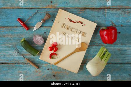 vintage recipe or cook book various vegetables and vintage kitchen utensils,free copy space Stock Photo