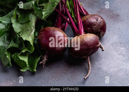 Organic beetroots with leaves on wooden cutting board, harvest time,  local healthy food, high angle view Stock Photo