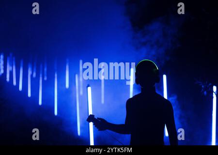 Silhouette of person in a smoky blue room Stock Photo