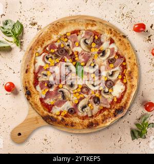 Delicious pizza with ham, mushrooms, corn, and olives resting on wooden board Stock Photo