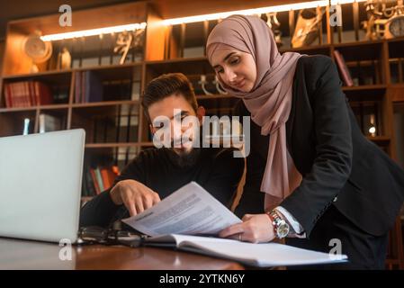 Business team of young man and Muslim woman working together on the project planning strategy in the modern office, business consultant meeting is Stock Photo