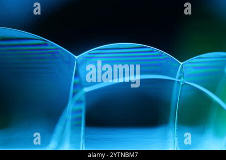Blue fluid reflections on black background, liquid abstraction, colour waves, deep dark backgrounds Stock Photo