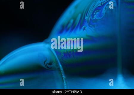 Blue fluid reflections on black background, liquid abstraction, colour waves, deep dark backgrounds Stock Photo