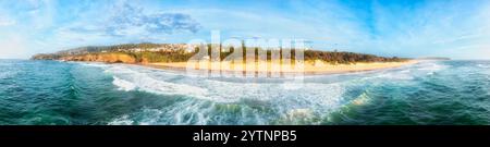 Scenic Caves beach coast of Australia on Pacific ocean - seaside aerial panoramic view of sea caves and town. Stock Photo