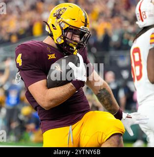 Arlington, Texas, USA. 7th Dec, 2024. Arizona State running back Cam Skattebo (4) gestures in a 'Heisman pose'' after scoring his third touchdown of the game during the second half of the Big 12 Championship between the Arizona State Sun Devils and the Iowa State Cyclones on December 7, 2024 in Arlington, Texas. Arizona State won, 45-19. (Credit Image: © Scott Coleman/ZUMA Press Wire) EDITORIAL USAGE ONLY! Not for Commercial USAGE! Stock Photo