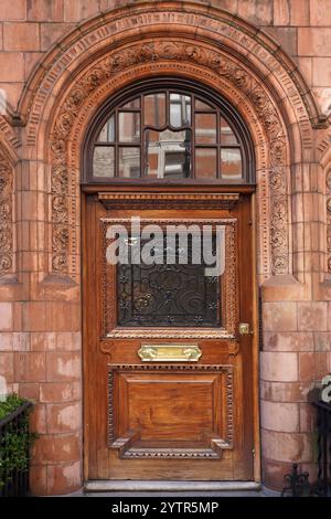 Front door of elegant apartment building with large flower pots Stock ...