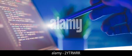 Work from home. Programmer coding code on notebook screen at Stock Photo