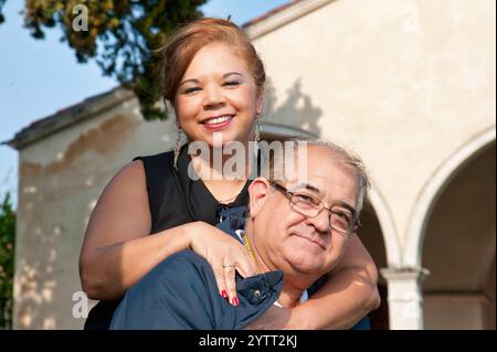 Close-up of a middle-aged couple hugging, smiling, and happy. Stock Photo