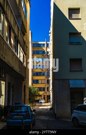 Life in a big city, old buildings, high-rise buildings, apartments for refugees, air conditioners on balconies Stock Photo