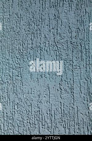 Blue faded surface, texture, background. Old decorated surface with vertical embossed strokes or stripes. Pale, light-blue wall surface Stock Photo
