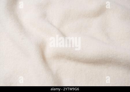Beige sweater texture as a background. Top view. Stock Photo