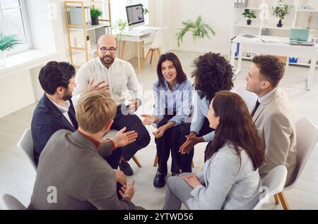 Young addict people talking on group therapy meeting sitting in circle discussing addiction, health  Stock Photo