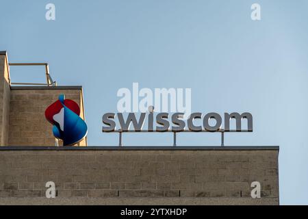 Sign and logo on a Swisscom telecommunications center. Swisscom AG is a public company and one of the leading Swiss telecommunications providers Stock Photo