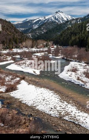 West Beckwith Mountain, in the West Elks range, rises above Coal Creek at its confluence with the North Fork of the Gunnison River Stock Photo