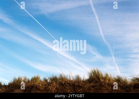 Aircraft con trails over the north Norfolk coast. Stock Photo