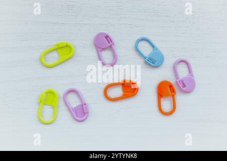 Bright knitting markers on white background. Colourful knitting pins. Knitting tools. Needlework accessories concept. Variety of knit markers. Stock Photo