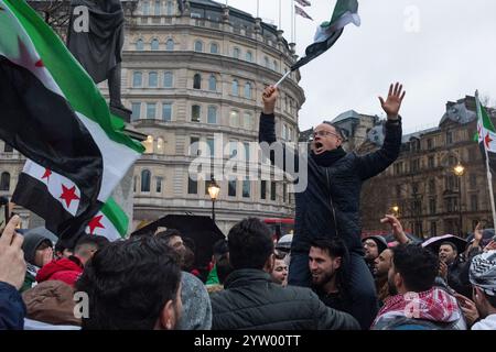 London, Uk, December 8th 2024. Celebration of the collapse of the Assad regime took place in Trafalgar Square, London, UK, with hundreds of Syrians joining as dusk fell over London. (Tennessee Jones - Alamy Live News) Stock Photo