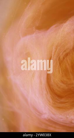Shining mist. Glitter swirl. Defocused pink orange color vapor cloud bright particles paint texture floating in water on abstract art background. Stock Photo
