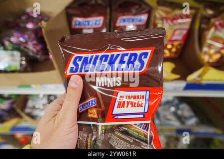 Tyumen, Russia-November 02, 2024: Snickers chocolate bar. Snickers bars are produced by Mars Incorporated. Stock Photo