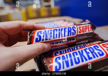Tyumen, Russia-November 02, 2024: Snickers bars are produced by Mars Incorporated. Snickers was created by Franklin Clarence Mars in 1930 Stock Photo