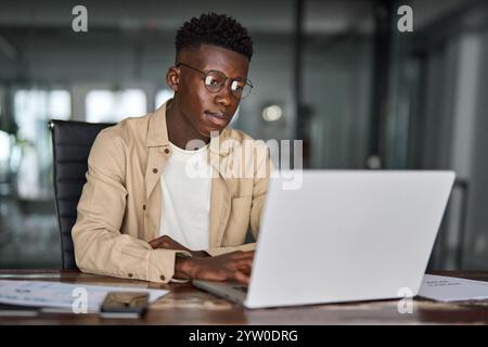 Busy African Black business man employee or student using laptop computer. Stock Photo