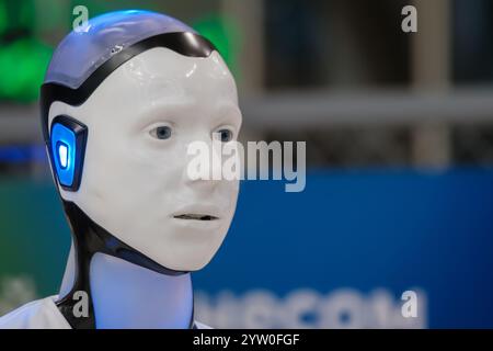 Humanoid robot with illuminated features showcases advanced technology and innovation at expo. Futuristic design emphasizes artificial intelligence. Stock Photo