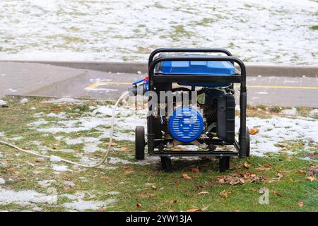 Portable gasoline or diesel generator to provide electricity. Problem with electricity. Blackout. Winter. Stock Photo