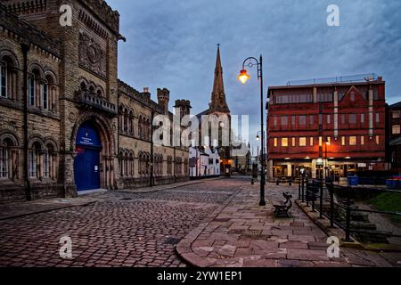 Evening brings the lights on Castle Street, Bury, Lancashire. Stock Photo