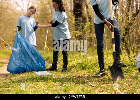 Team of environmentalists picking up rubbish from the woods, fight ...