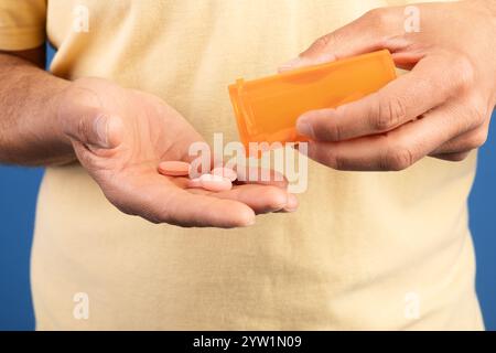 Mature man managing medication for health in a calm setting Stock Photo