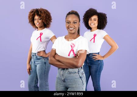 Empowered women supporting each other with pink ribbons in friendship Stock Photo