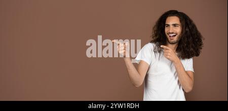 Young man with curly hair showcases playful lifestyle against a brown backdrop Stock Photo