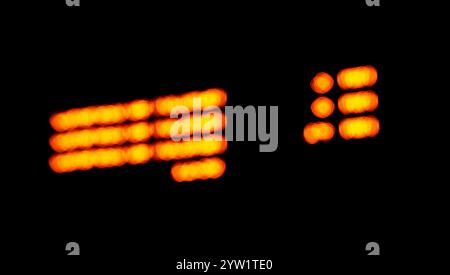 Orange bokeh lights in circles defocused against a black background Stock Photo