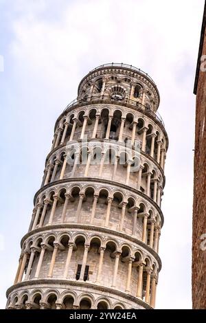 Leaning Tower of Pisa, Tuscany, Italy. For comparison a nearby building edge is on the right to give a sense of the angle of the Tower's lean. Stock Photo