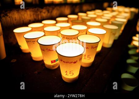 Nijmegen, Netherlands. 08th Dec, 2024. A view of paper cups carrying candles on the cups are the names and ages of children killed in the war, to commemorate World Candle Day. Around 18,000 candles were lit to remember all deceased children in the Palestine-Israel-Lebanon region. The candles were placed along the stairs leading to the quay on the Waal in Nijmegen. At the same time, the names of the children who died in the war in the past year were read by people attending the event. Credit: SOPA Images Limited/Alamy Live News Stock Photo