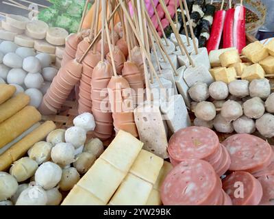 An arrangement of processed meat Thai street food at a market stall in Thailand. Stock Photo