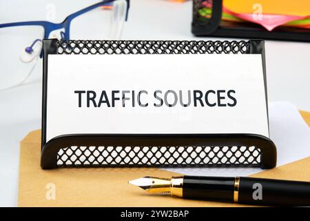 Business concept. Text TRAFFIC SOURCES close-up, front view on a business card in a stand. Stock Photo