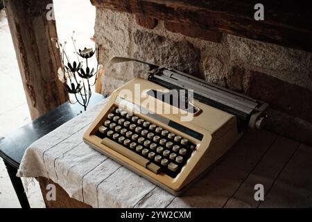 An old antique typewriter becomes a decoration in a vintage style home Stock Photo