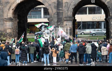 Syrians celebrate after Assad regime toppled, war in the middle east, rebels and islamists, Porta Nigra in Trier, Germany, 08.12.2024 Stock Photo