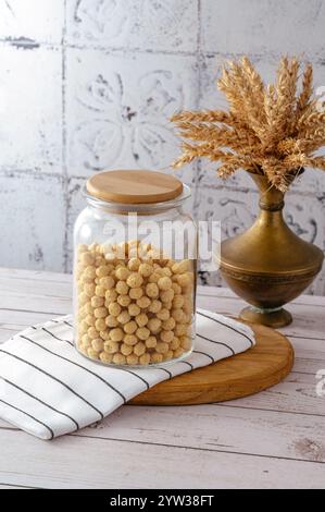 cornflakes in a jar with a wooden lid Stock Photo