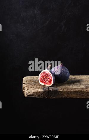 Fresh figs on an old wooden plank on a dark background Stock Photo