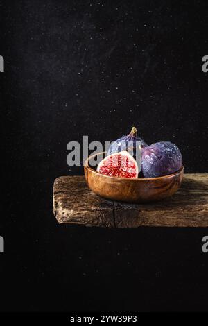 Fresh figs in a wooden bowl on a dark background Stock Photo