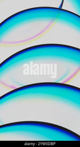 Illustration of curved lines of iridescent color against a pale blue background Stock Photo